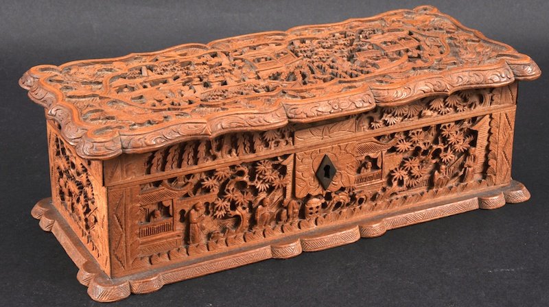 A GOOD 19TH CENTURY CHINESE CARVED CANTON SANDALWOOD CA: A GOOD 19TH CENTURY CHINESE CARVED CANTON SANDALWOOD CASKET carved with foliage and panels of figures within landscapes, upon a shaped base. Good condition. 10.25ins wide.