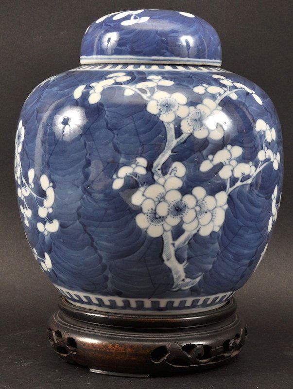 A 19TH CENTURY CHINESE BLUE AND WHITE GINGER JAR AND CO: A 19TH CENTURY CHINESE BLUE AND WHITE GINGER JAR AND COVER bearing Kangxi marks to base, painted with flowering prunus. Good condition. Jar 7.5ins high.