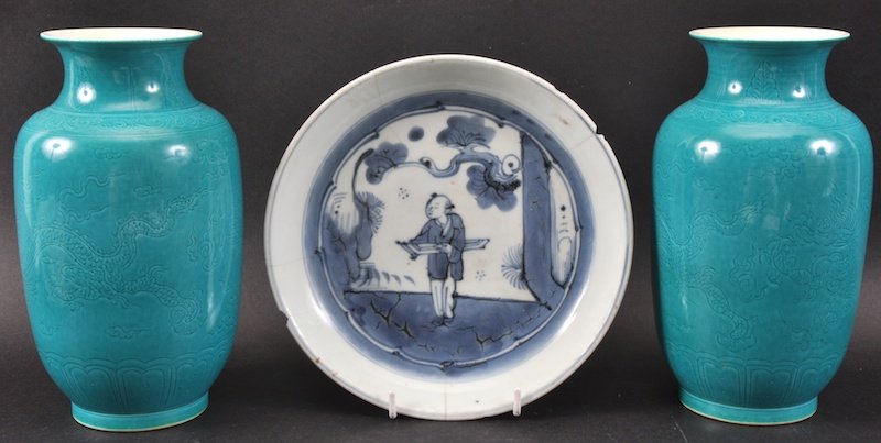 AN 18TH CHIESE BLUE AND WHITE CIRCULAR PLATE painted wi: AN 18TH CHIESE BLUE AND WHITE CIRCULAR PLATE painted with a figure within a landscape, together with a pair of blue glazed porcelain dragon vases. Plate damaged, vases with fritting. 8ins diameter. & 