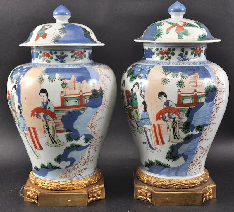 A FINE PAIR OF 17TH CENTURY CHINESE WUCAI GINGER JARS A: A FINE PAIR OF 17TH CENTURY CHINESE WUCAI GINGER JARS AND COVERS Transitional C1660, painted with scholars and immortals within a landscape, with French ormolu mounts. 1ft 5ins high.