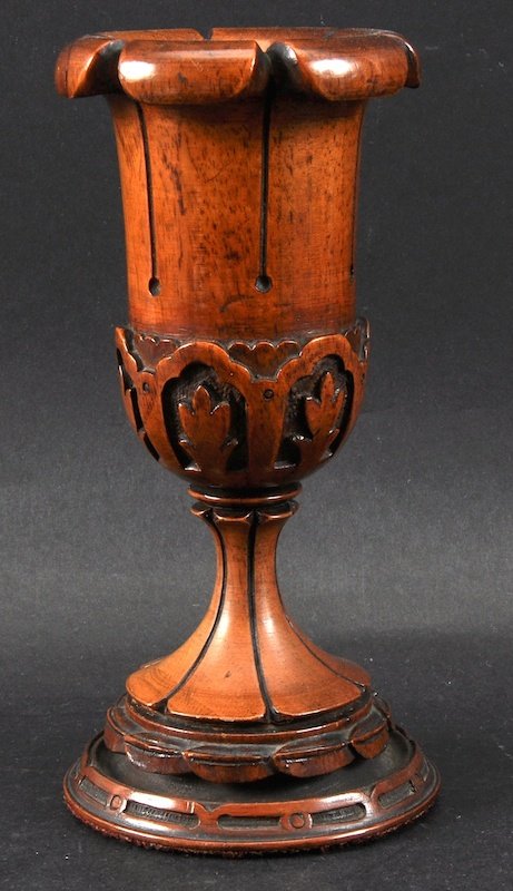 A CARVED WOOD PEDESTAL CHALICE. 7ins high.: A CARVED WOOD PEDESTAL CHALICE. 7ins high.