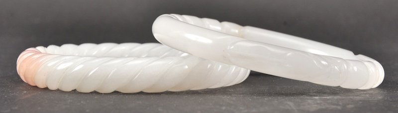 A PAIR OF CHINESE WHITE JADE CIRCULAR BANGLES. Good: A PAIR OF CHINESE WHITE JADE CIRCULAR BANGLES. Good condition. 3ins diameter.