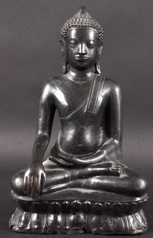 A 19TH CENTURY SOUTH EAST ASIAN BRONZE BUDDHA modelled: A 19TH CENTURY SOUTH EAST ASIAN BRONZE BUDDHA modelled upon a triangular base. Minor losses. 9ins high.
