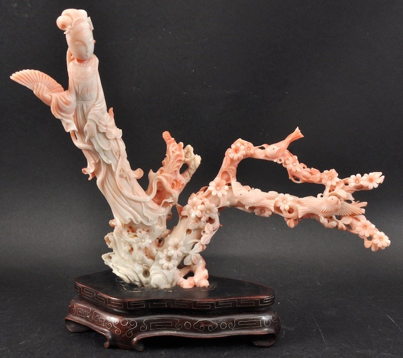 A CHINESE QING DYNASTY CARVED RED CORAL FIGURE OF