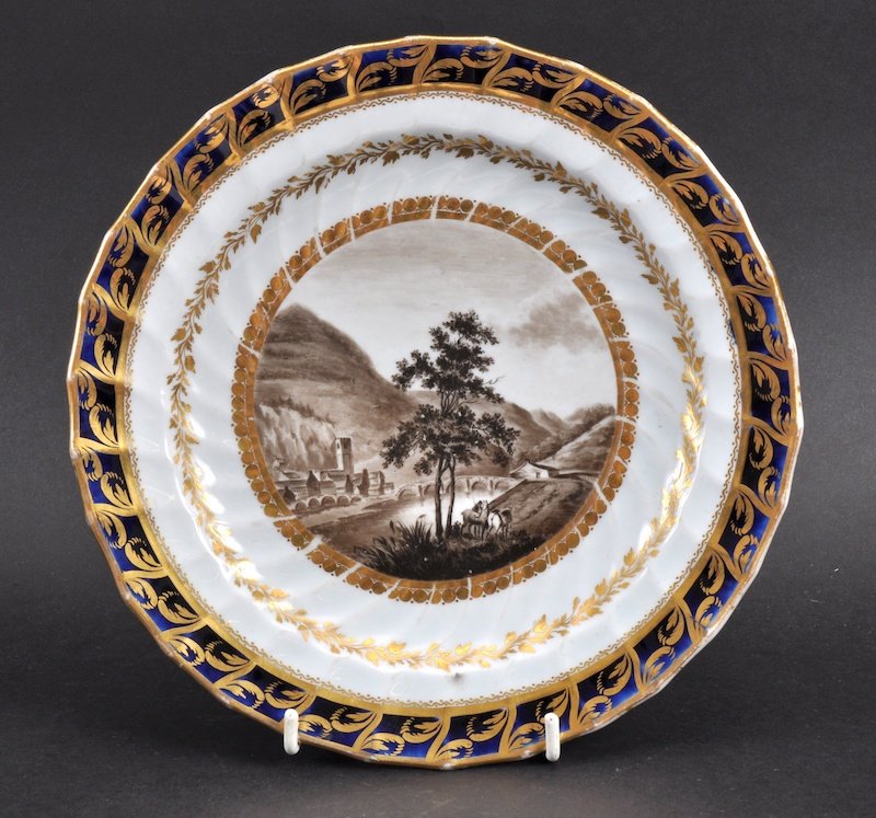 A LATE 18TH CENTURY CHAMBERLAINS WORCESTER PLATE: A LATE 18TH CENTURY CHAMBERLAINS WORCESTER PLATE painted with a landscape entitled Dolgelly. 8.25ins wide.