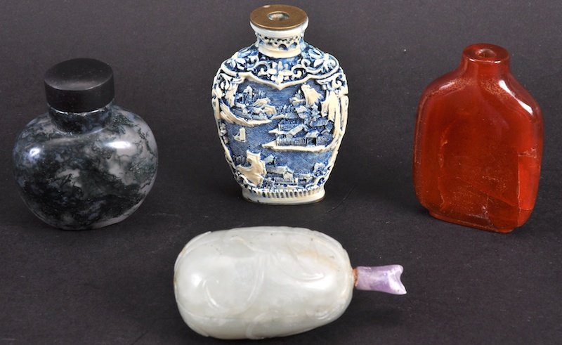 A 19TH CENTURY CHINESE CARVED WHITE JADE SNUFF BOTTLE: A 19TH CENTURY CHINESE CARVED WHITE JADE SNUFF BOTTLE AND STOPPER together with three other snuff bottles. 2 lacking stoppers. Largest 3.5ins high. (4)4
