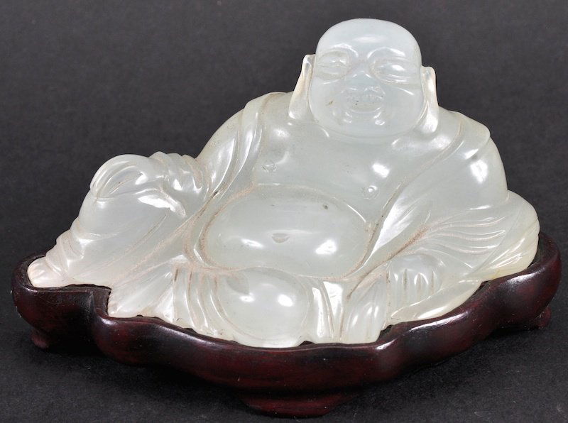 A 19TH CENTURY CHINESE CARVED WHITE JADE FIGURE OF A: A 19TH CENTURY CHINESE CARVED WHITE JADE FIGURE OF A BUDDHA modelled sleeping in robes. Good condition. Jade 3.75ins wide.