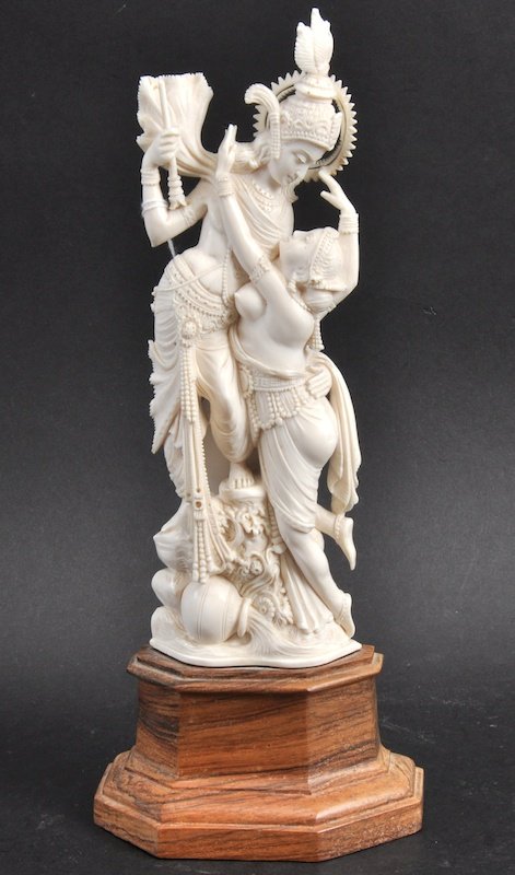 AN EARLY 20TH CENTURY INDIAN IVORY FIGURE OF A MALE AND: AN EARLY 20TH CENTURY INDIAN IVORY FIGURE OF A MALE AND FEMALE modelled upon a turned base. Ivory 8.25ins high.