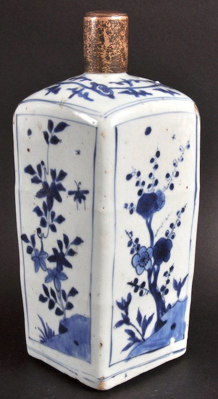 A 17TH CENTURY CHINESE BLUE AND WHITE SQUARE FORM FLASK: A 17TH CENTURY CHINESE BLUE AND WHITE SQUARE FORM FLASK Painted with flowering rock. Hairline to rim, fritting. 10.5ins high.