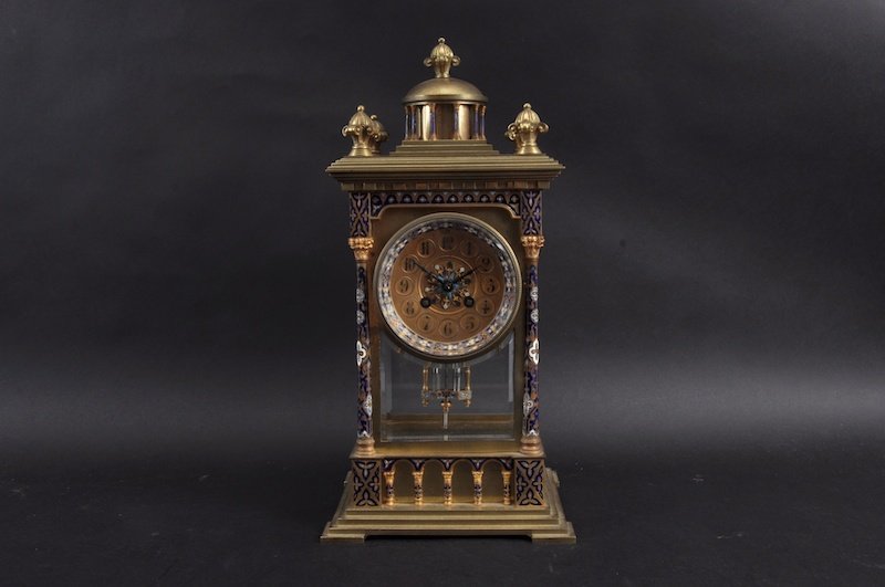 A GOOD 19TH CENTURY FRENCH CHAMPLEVE ENAMEL GOTHIC: A GOOD 19TH CENTURY FRENCH CHAMPLEVE ENAMEL GOTHIC STYLE CLOCK by A. HOUGIN striking on a gong with column supports. 17ins high.