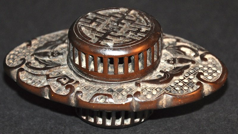 AN EARLY 20TH CENTURY CHINESE CARVED HORN CRICKET CAGE: AN EARLY 20TH CENTURY CHINESE CARVED HORN CRICKET CAGE AND COVER carved with bats. Small loss to rim. 3.25ins wide.