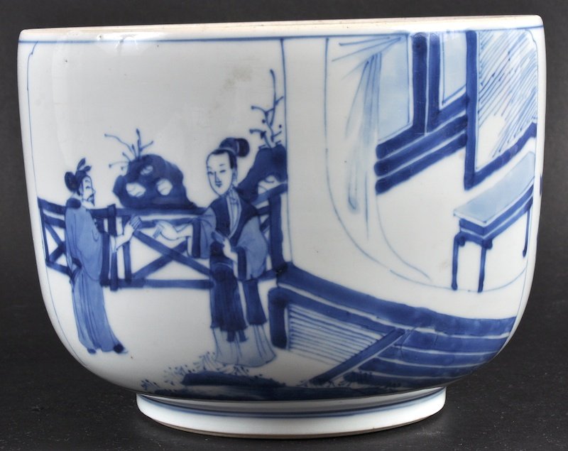 A CHINESE QING DYNASTY BLUE AND WHITE CIRCULAR JAR poss: A CHINESE QING DYNASTY BLUE AND WHITE CIRCULAR JAR possibly Kangxi, painted with figures within garens. Small graze to rim. 8ins diameter.