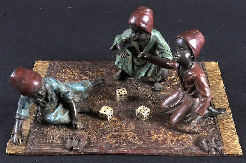 A COLD CAST GROUP, THREE ARAB BOYS sitting on a carpet : A COLD CAST GROUP, THREE ARAB BOYS sitting on a carpet playing dice. 7.5ins wide.