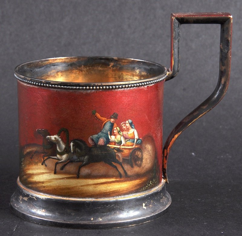 A RUSSIAN SILVER AND RED LACQUER TANKARD decorated with: A RUSSIAN SILVER AND RED LACQUER TANKARD decorated with figures in a two horse drawn carriage. Stamped MOP030B6. Maker: BK. 84 mark with head.
