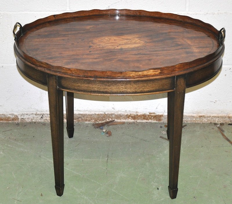 A GEORGIAN MAHOGANY OVAL TWO HANDLED TRAY with crossban: A GEORGIAN MAHOGANY OVAL TWO HANDLED TRAY with crossbanding and satinwood shell inlay, brass handles on a later stand. 2ft 4ins wide.