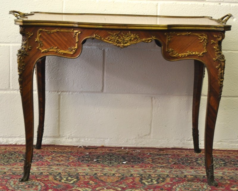 A GOOD 19TH CENTURY KINGWOOD INLAID SERVING TABLE with : A GOOD 19TH CENTURY KINGWOOD INLAID SERVING TABLE with rich ormolu mounts and carrying handles on slender curing legs in the manner of F. LINKE. Bears label WILKINSON & SON, 8 OLD BOND STREET, LONDON.