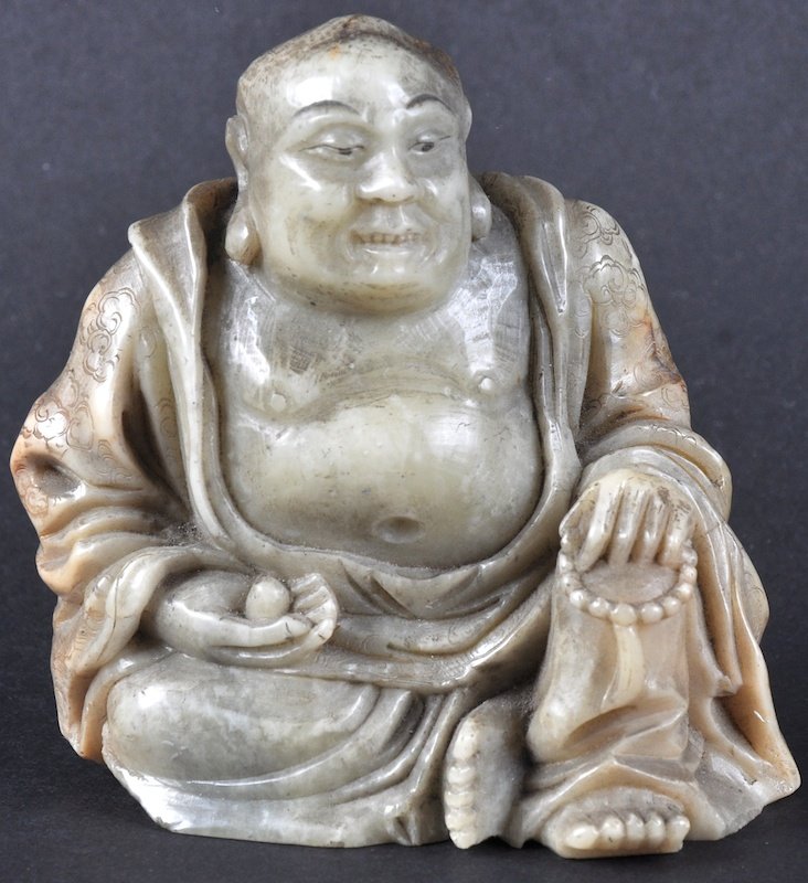 A 19TH CENTURY CHINESE CARVED SOAPSTONE FIGURE OF A: A 19TH CENTURY CHINESE CARVED SOAPSTONE FIGURE OF A BUDDHA modelled seated holding beads. Natural fissures. 3.75ins high.