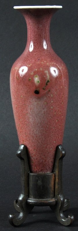 A CHINESE QING DYNASTY PEACH BLOOM TAPERING VASE: A CHINESE QING DYNASTY PEACH BLOOM TAPERING VASE bearing Kangxi marks to base, upon a hardwood stand. Rim chip. 5.5ins high.