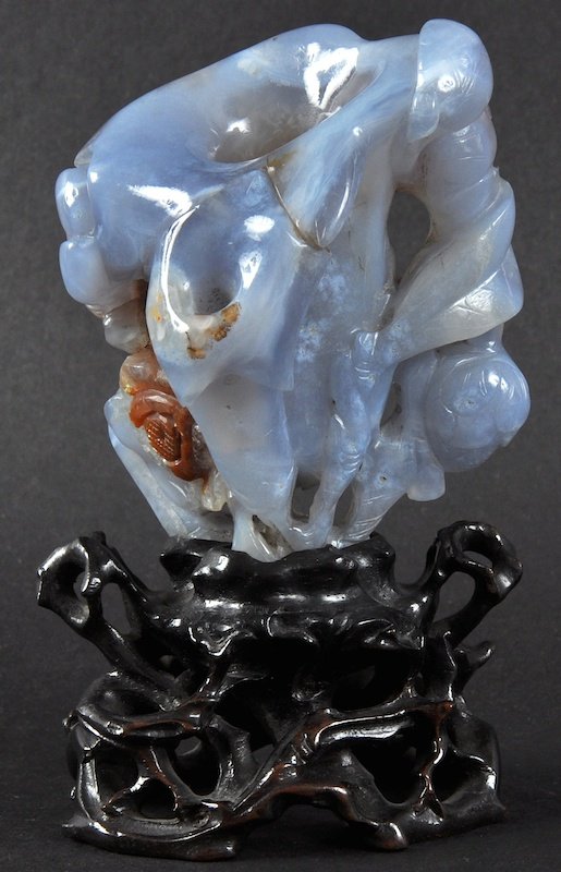 A 19TH CENTURY CHINESE CARVED CHALCEDONY VASE in the: A 19TH CENTURY CHINESE CARVED CHALCEDONY VASE in the form of a trumpet bloom, the stone of milky blue tones. Vase 3.5ins high.