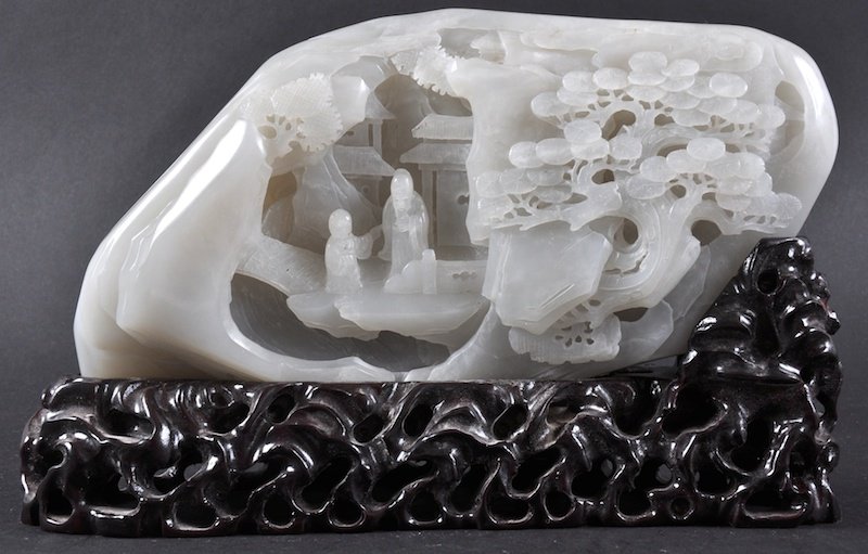 AN EARLY 20TH CENTURY CHINESE CARVED WHITE JADE MOUNTAI: AN EARLY 20TH CENTURY CHINESE CARVED WHITE JADE MOUNTAIN carved with two seated scholars within a landscape. Good condition. Jade 9ins wide.