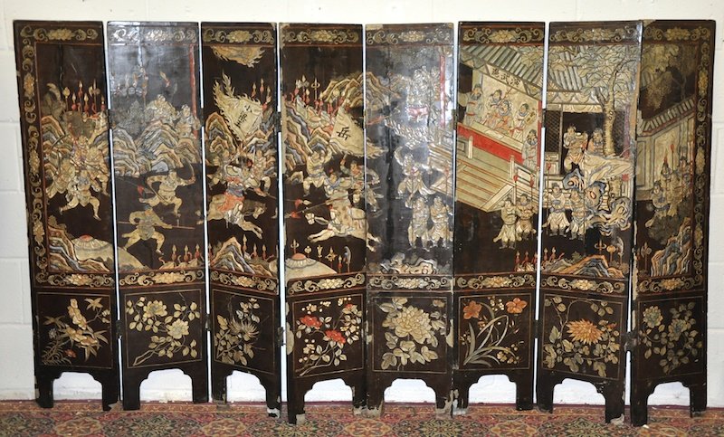 A 19TH CENTURY CHINESE EIGHT PANEL FOLDING SCREEN with: A 19TH CENTURY CHINESE EIGHT PANEL FOLDING SCREEN with carved and polychromed figural decoration. 7ft 4ins x 4ft 2ins.