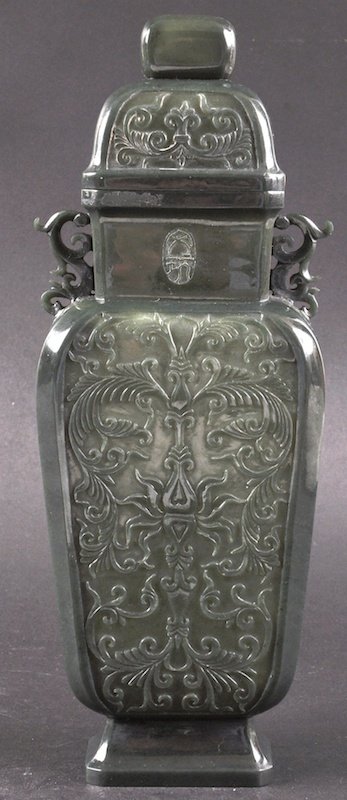 AN EARLY 20TH CENTURY CHINESE CARVED SPINACH JADE VASE: AN EARLY 20TH CENTURY CHINESE CARVED SPINACH JADE VASE AND COVER Mughal style, carved with extensive foliage. Signed. Repair to finial. 10.25ins high.
