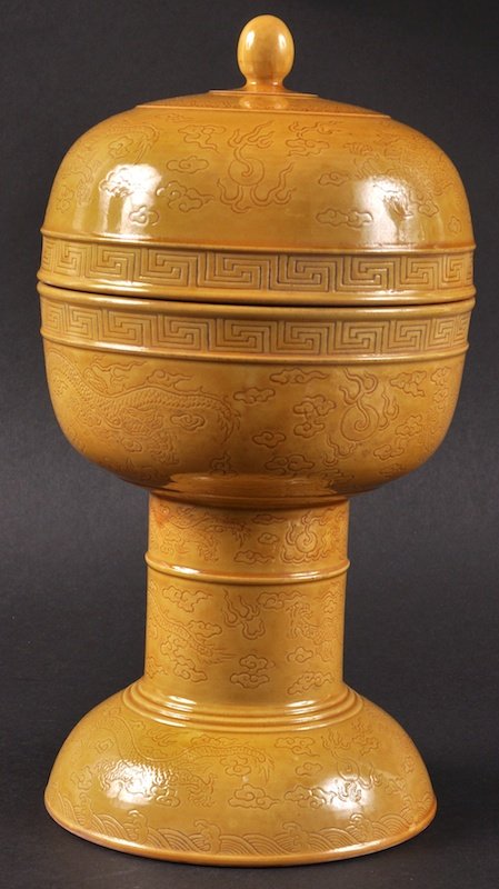A GOOD CHINESE YELLOW GROUND ALTAR VESSEL AND COVER: A GOOD CHINESE YELLOW GROUND ALTAR VESSEL AND COVER Dou, Daoguang mark and possibly of the period, decorated with incised dragons and clouds. Crazing, small cover nick. 11.5ins high.