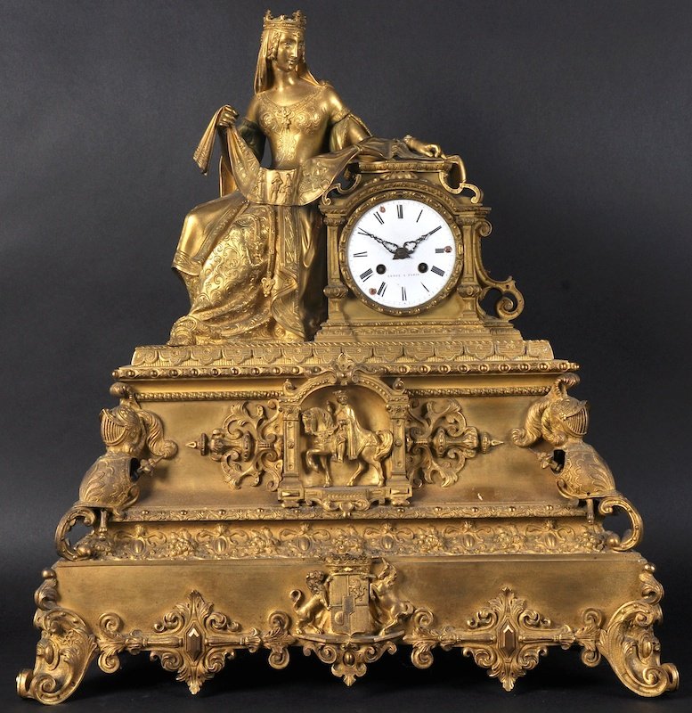 A LARGE 19TH CENTURY FRENCH ORMOLU CLOCK with white: A LARGE 19TH CENTURY FRENCH ORMOLU CLOCK with white circular dial, and movement by LEROY A. PARIS, of Classical form, surmounted with a Queen holding a scroll, the case with suits of armour, heraldic