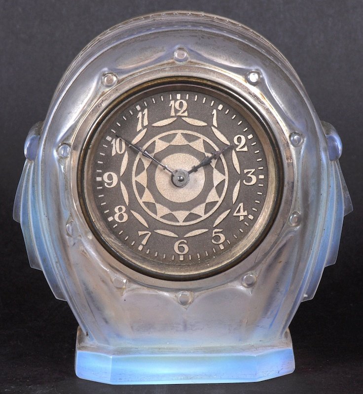 A SABINO GLASS CASED CLOCK in iridescent blue, with: A SABINO GLASS CASED CLOCK in iridescent blue, with circular case. 4.5 inches high/