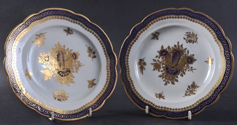 AN 18TH CENTURY CAUGHLEY PAIR OF PLATES painted in: AN 18TH CENTURY CAUGHLEY PAIR OF PLATES painted in under-glaze blue and gilded probably by Chamberlains “S” mark in under-glaze blue.