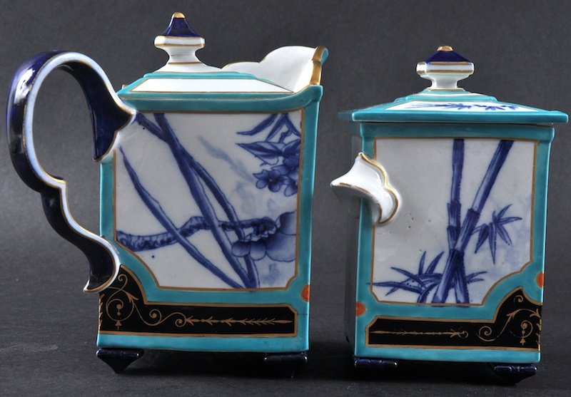 A VERY RARE ROYAL WORCESTER PORCELAIN JAPANESQUE TEAPOT: A VERY RARE ROYAL WORCESTER PORCELAIN JAPANESQUE TEAPOT & COVER AND MATCHING SUCRIER & COVER painted with bamboo, birds and prunus blossoms in panels surrounds by turquoise and a gilt black lacquer st