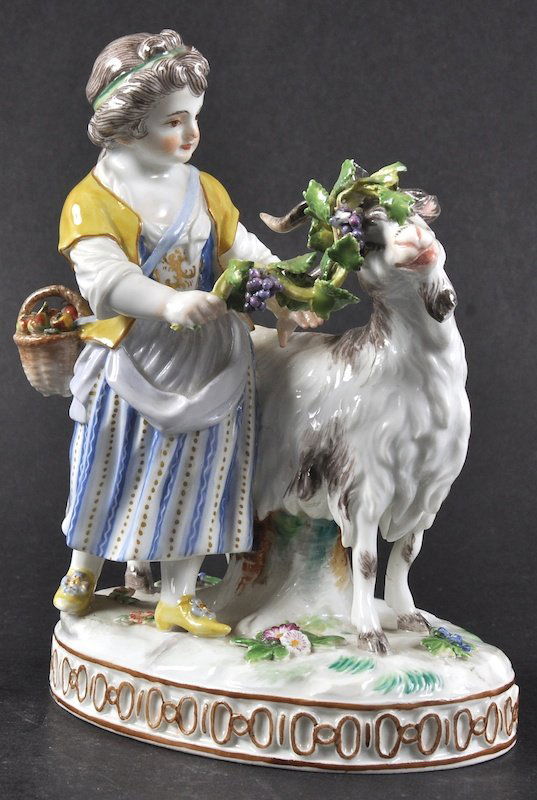 A 20TH CENTURY MEISSEN GROUP OF A YOUNG GIRL with a: A 20TH CENTURY MEISSEN GROUP OF A YOUNG GIRL with a goat on an oval base. Cross Swords Mark in Blue. 5.5ins high.
