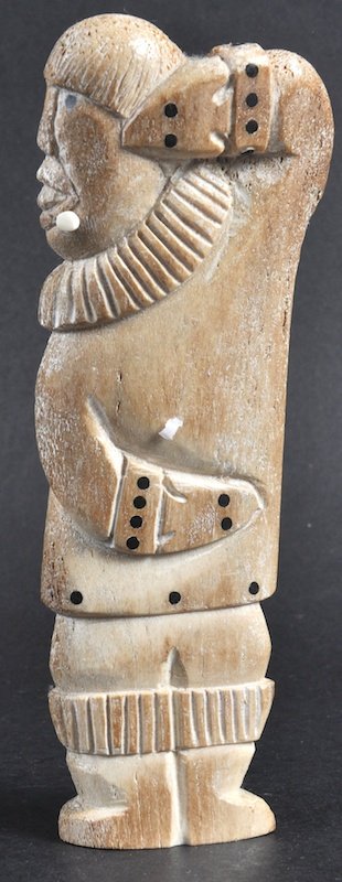A 19TH CENTURY ESKIMO INUIT CARVED BONE FIGURE OF A: A 19TH CENTURY ESKIMO INUIT CARVED BONE FIGURE OF A MAN. 7.5ins long.