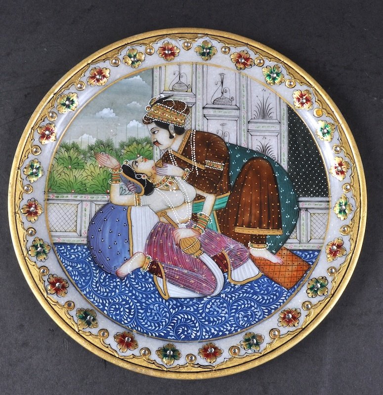 AN INDIAN MARBLE CIRCULAR PLATE, painted with a scene: AN INDIAN MARBLE CIRCULAR PLATE, painted with a scene of young lovers. 9ins diameter.