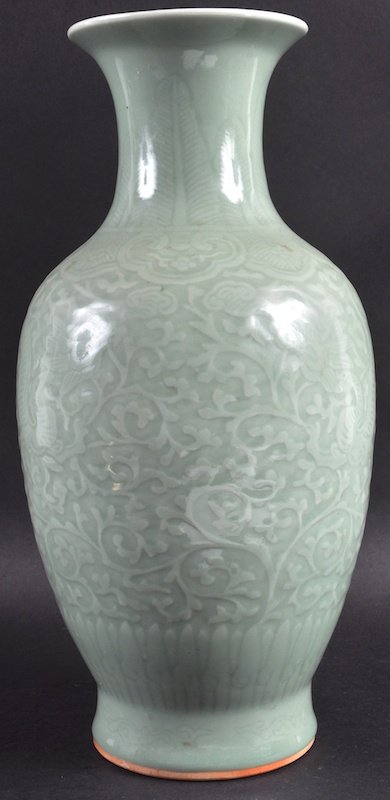 A 19TH CENTURY CHINESE GREEN CELADON PORCELAIN VASE: A 19TH CENTURY CHINESE GREEN CELADON PORCELAIN VASE bearing Qianlong marks to base, decorated with dragons amongst foliage. Good condition. 15.5ins high.