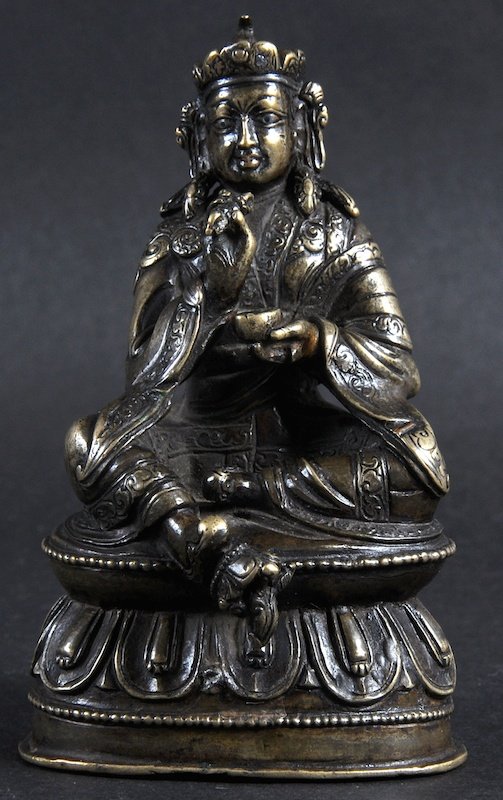 A 19TH CENTURY SINO NEPALESE BRONZE FIGURE OF A BUDDHA: A 19TH CENTURY SINO NEPALESE BRONZE FIGURE OF A BUDDHA depicted upon a triangular base. 3.75ins high.