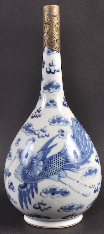 AN 18TH CENTURY CHINESE BLUE AND WHITE VASE painted: AN 18TH CENTURY CHINESE BLUE AND WHITE VASE painted with phoenix birds amongst clouds. Flaw to body. 10.5ins high.