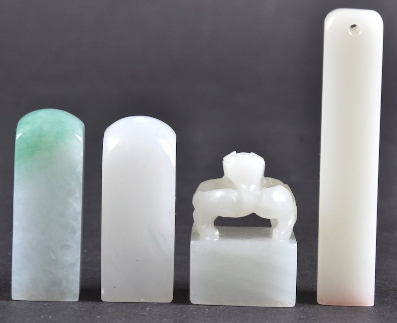 A LOVELY EARLY 20TH CENTURY CHINESE CARVED WHITE JADE: A LOVELY EARLY 20TH CENTURY CHINESE CARVED WHITE JADE SEAL together with three other jade & jadeite seals. Minor nick to one. (4)