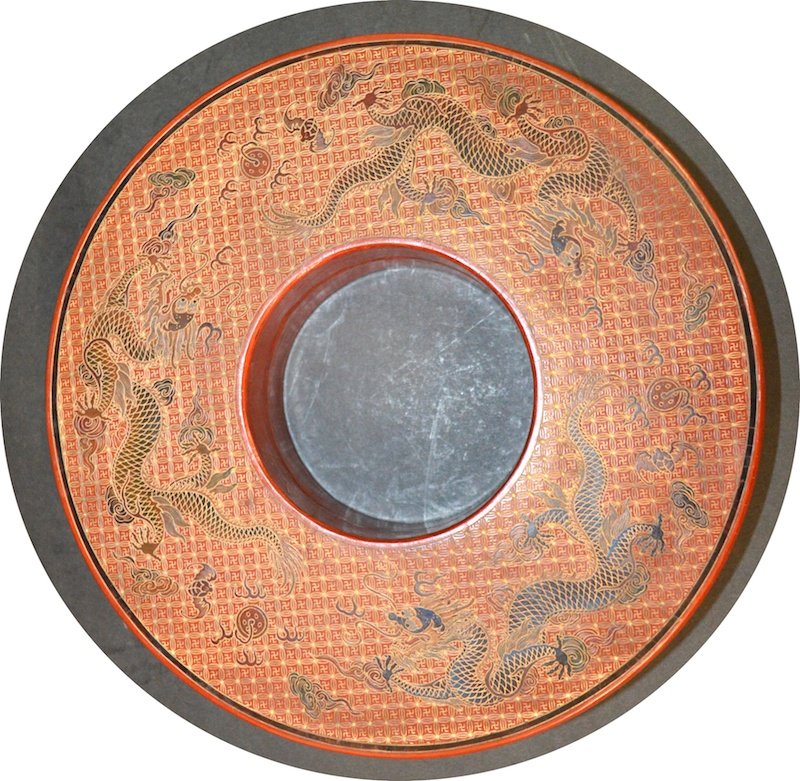 A CHINESE RED LACQUER CIRCULAR BOX AND COVER bearing: A CHINESE RED LACQUER CIRCULAR BOX AND COVER bearing Qianlong marks to base, decorated with five claw dragons. Minor crazing. 10ins diameter.