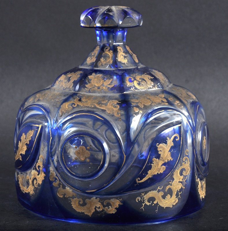 A 19TH CENTURY BOHEMIAN CIRCULAR CHEESE BELL of: A 19TH CENTURY BOHEMIAN CIRCULAR CHEESE BELL of octagonal form decorated with scrolls and gilt decoration. 4.25ins diameter.