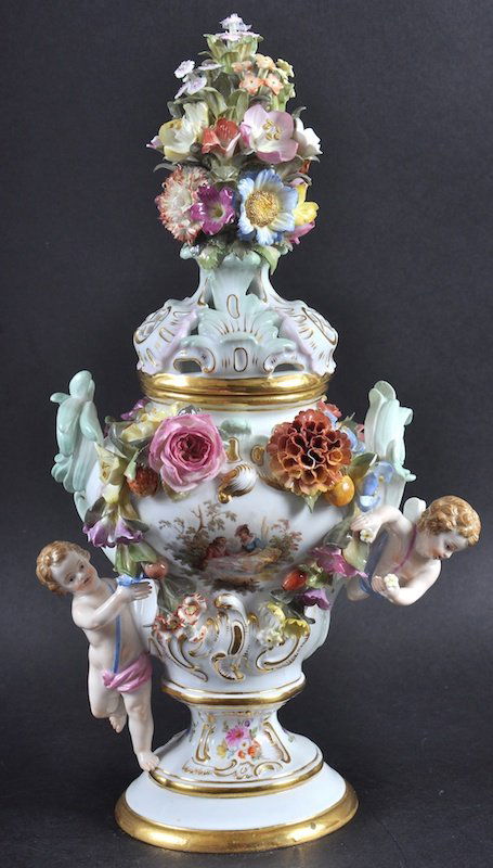A VERY GOOD 19TH CENTURY MEISSEN URN SHAPED VASE AND: A VERY GOOD 19TH CENTURY MEISSEN URN SHAPED VASE AND COVER encrusted with flowers, with two applied cupids, the body painted with reverse panels of young lovers and flowers. Cross Swords Mark in Blue.