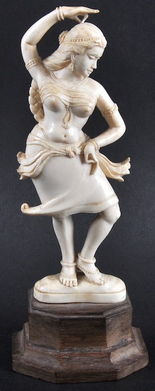 AN INDIAN CARVED IVORY FIGURE OF A YOUNG LADY DANCER.: AN INDIAN CARVED IVORY FIGURE OF A YOUNG LADY DANCER. 6ins high, on a wooden plinth.