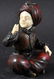 A SMALL BRONZE AND IVORY FIGURE OF A SEATED ARAB BOY,