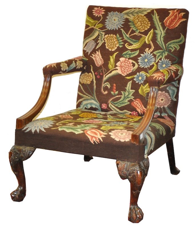 AN 18TH CENTURY GEORGIAN WALNUT GAINSBOROUGH CHAIR with: AN 18TH CENTURY GEORGIAN WALNUT GAINSBOROUGH CHAIR with floral needlework back, arms and seat, the frame with show wood curving arms, cabriole legs carved with acanthus and ending in claw and ball fee