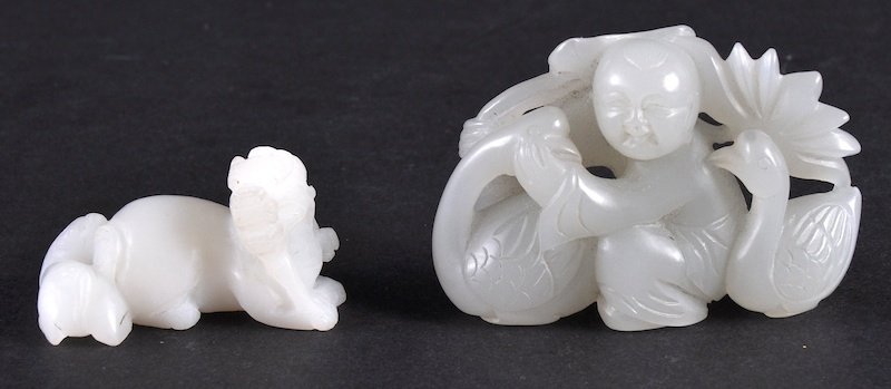 AN EARLY 20TH CENTURY CHINESE CARVED WHITE JADE FIGURE: AN EARLY 20TH CENTURY CHINESE CARVED WHITE JADE FIGURE OF A BOY together with a hardstone figure of a dragon. Good condition. (2)