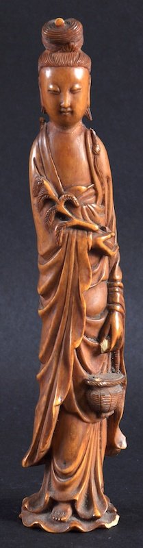 A CHINESE QING DYNASTY STAINED IVORY FIGURE OF GUANYIN: A CHINESE QING DYNASTY STAINED IVORY FIGURE OF GUANYIN possibly Late Qianlong, modelled standing holding a basket. Loss to hand, head re attached. 7. 75ins high.