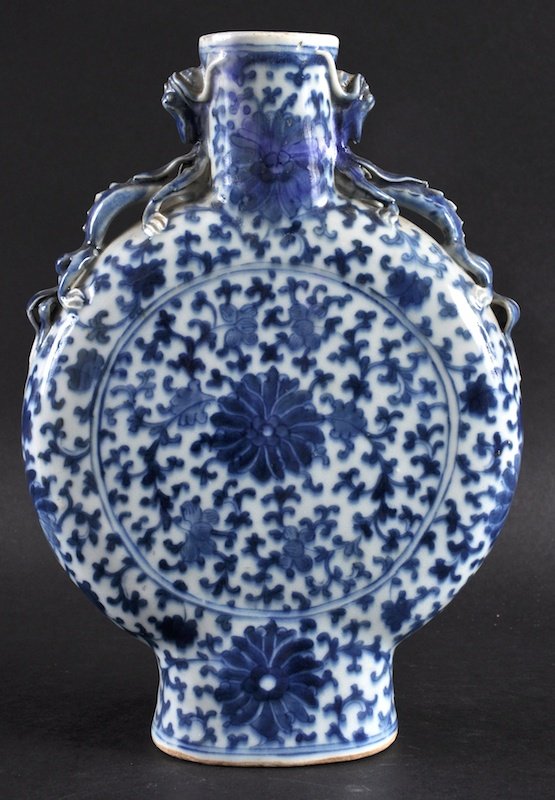 A 19TH CENTURY CHINESE BLUE AND WHITE MOON FLASK: A 19TH CENTURY CHINESE BLUE AND WHITE MOON FLASK Qianlong style, painted with bold floral sprays. Minor neck restoration. 10. 25ins high.