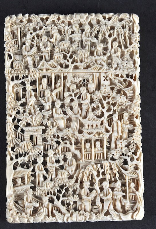 A 19TH CENTURY CHINESE CARVED CANTON IVORY CARD CASE: A 19TH CENTURY CHINESE CARVED CANTON IVORY CARD CASE AND COVER decorated with figures within landscapes. Tiny loss to cover. 4. 5ins x 2. 75ins.