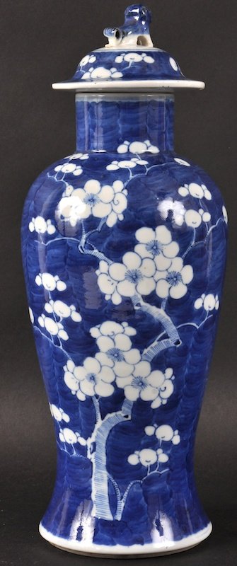 A 19TH CENTURY CHINESE BLUE AND WHITE BALUSTER VASE AND: A 19TH CENTURY CHINESE BLUE AND WHITE BALUSTER VASE AND COVER painted with flowers. Tiny rim chip. 13. 5ins high.