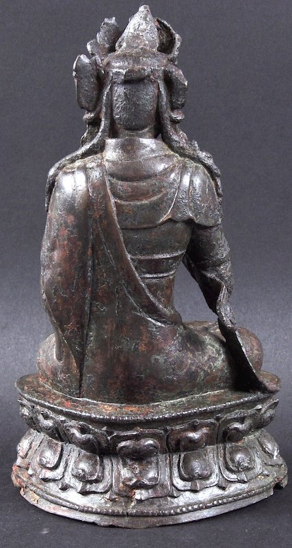 A 16TH/17TH CENTURY CHINESE BRONZE FIGURE OF GUANYIN: A 16TH/17TH CENTURY CHINESE BRONZE FIGURE OF GUANYIN Ming, enamel remnants, modelled with hand raised upon a triangular lotus base. Minor faults. 8ins high.